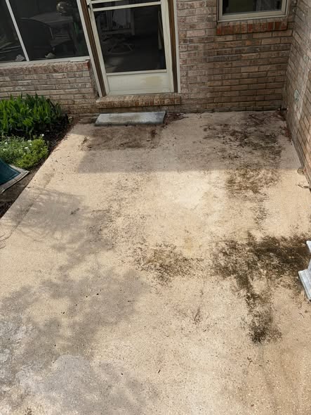 Stained, dirty concrete patio before pressure washing